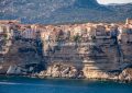 brown concrete building on cliff by the sea during daytime
