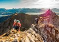 2 men hiking on mountain during daytime