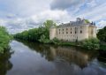 a large building sitting on the side of a river