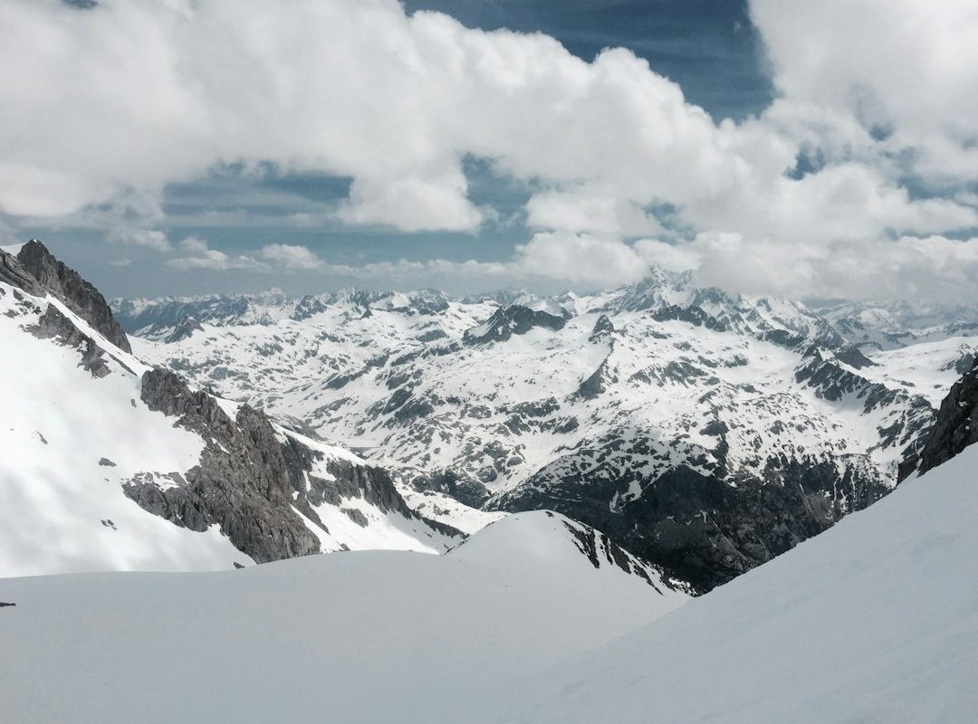 mountain alps under cumulus clouds