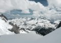 mountain alps under cumulus clouds